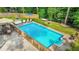 Beautiful backyard pool area with a seating area, a hammock, and mature trees at 2666 Peachtree Walk, Duluth, GA 30096