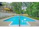 Gorgeous backyard pool and patio with manicured landscaping and multi-level decks at 2666 Peachtree Walk, Duluth, GA 30096