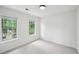 Bright, carpeted bedroom featuring two windows providing natural light at 2201 Logan Dr, Jonesboro, GA 30236