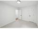 Neutral carpeted bedroom featuring a door and white walls at 2201 Logan Dr, Jonesboro, GA 30236