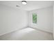 Cozy bedroom with white walls, neutral carpeting, and a window providing natural light at 2201 Logan Dr, Jonesboro, GA 30236