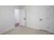 Neutral carpeted bedroom featuring a door, closet, and white walls at 2201 Logan Dr, Jonesboro, GA 30236