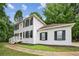Charming two-story home with white brick, black shutters, and a manicured lawn at 2201 Logan Dr, Jonesboro, GA 30236