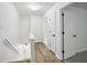 Bright hallway with wood floors, white walls, and modern doors at 2201 Logan Dr, Jonesboro, GA 30236