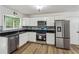Well-lit kitchen with granite countertops, stainless steel appliances, and white cabinets at 2201 Logan Dr, Jonesboro, GA 30236