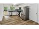 Modern kitchen featuring stainless steel appliances, white cabinets and door to the backyard at 2201 Logan Dr, Jonesboro, GA 30236