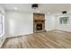 Bright living room with hard wood flooring, stone fireplace and lots of natural light at 2201 Logan Dr, Jonesboro, GA 30236
