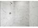 Modern walk-in shower featuring white marble-look tile and pebble flooring at 2201 Logan Dr, Jonesboro, GA 30236