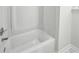 Clean white bathtub with silver fixtures and tiled flooring at 2201 Logan Dr, Jonesboro, GA 30236
