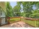 Wooden deck with view of large backyard and many trees at 62 Sweetwater Pkwy, Powder Springs, GA 30127