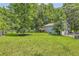Expansive backyard featuring a deck and mature trees at 62 Sweetwater Pkwy, Powder Springs, GA 30127