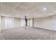 Spacious finished basement with neutral carpet and multiple entryways at 62 Sweetwater Pkwy, Powder Springs, GA 30127