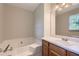 Bathroom with tub, vanity and wooden cabinets, creating a functional space at 62 Sweetwater Pkwy, Powder Springs, GA 30127