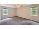 Well-lit bedroom with windows, ceiling fan, and carpet, creating a peaceful atmosphere at 62 Sweetwater Pkwy, Powder Springs, GA 30127