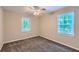 Bright bedroom with windows, ceiling fan, and carpet flooring for a comfortable feel at 62 Sweetwater Pkwy, Powder Springs, GA 30127