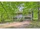 Traditional home with a cozy front porch and classic design details surrounded by lush trees at 62 Sweetwater Pkwy, Powder Springs, GA 30127