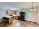 Well-equipped kitchen with wooden cabinets, breakfast bar, and modern appliances, perfect for culinary enthusiasts at 62 Sweetwater Pkwy, Powder Springs, GA 30127