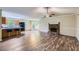 Open-concept living space featuring hardwood floors, stone fireplace, and a view of the modern kitchen at 62 Sweetwater Pkwy, Powder Springs, GA 30127