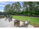 Grassy backyard with a rock fire pit and relaxing rocking chairs at 6329 Granbury Walk, Acworth, GA 30101