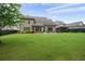 Lush backyard with a covered patio and a grill perfect for outdoor entertaining at 6329 Granbury Walk, Acworth, GA 30101