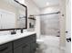 Beautiful bathroom featuring a white vanity with marble countertop and tiled shower at 6329 Granbury Walk, Acworth, GA 30101