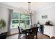 Bright dining room features a modern light fixture, dark wood table set, and a beverage bar at 6329 Granbury Walk, Acworth, GA 30101
