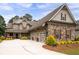 Lovely exterior with attached three car garage, complemented by stone accents and manicured landscaping at 6329 Granbury Walk, Acworth, GA 30101