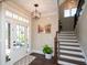 Bright entryway with hardwood floors, staircase, and a charming view of the front porch at 6329 Granbury Walk, Acworth, GA 30101