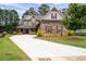 Charming two-story home with inviting front porch, lush landscaping, and a long driveway at 6329 Granbury Walk, Acworth, GA 30101