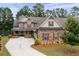 Beautiful exterior of craftsman-style home with stone accents, shutters, and a well-manicured lawn at 6329 Granbury Walk, Acworth, GA 30101