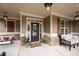 Welcoming front entrance with a covered porch, outdoor seating, and elegant decor at 6329 Granbury Walk, Acworth, GA 30101