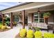 Charming covered porch with comfortable seating, hanging plants, and decorative lanterns at 6329 Granbury Walk, Acworth, GA 30101