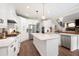 Open kitchen featuring white cabinets, a center island, and stainless steel appliances at 6329 Granbury Walk, Acworth, GA 30101