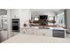 Open concept kitchen with views into the living room, white cabinets, and stone countertops at 6329 Granbury Walk, Acworth, GA 30101