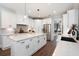 Modern kitchen with white cabinets, quartz countertops, and stainless steel appliances at 6329 Granbury Walk, Acworth, GA 30101
