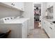 Well-lit laundry room featuring modern washer and dryer with access to the closet at 6329 Granbury Walk, Acworth, GA 30101