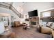 Living room with a stone fireplace, wood floors, staircase, and open floor plan at 6329 Granbury Walk, Acworth, GA 30101