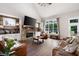 Inviting living room featuring a stone fireplace, high ceilings, and abundant natural light at 6329 Granbury Walk, Acworth, GA 30101