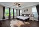 Spacious bedroom with tray ceiling, hardwood floors, and large windows at 6329 Granbury Walk, Acworth, GA 30101