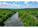 An aerial view of a river, surrounded by a vibrant, dense forest, under a partly cloudy sky at 1385 Northcliff Trce, Roswell, GA 30076