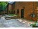 Brick home with stone patio and landscaped backyard at 1385 Northcliff Trce, Roswell, GA 30076