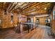 Unfinished basement with open ceiling, hardwood flooring and ping pong table at 1385 Northcliff Trce, Roswell, GA 30076