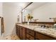 Bathroom with a granite countertop, double sinks, and wooden cabinetry at 1385 Northcliff Trce, Roswell, GA 30076
