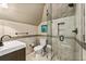 Cozy bathroom featuring neutral tile, mosaic accent, modern fixtures, and a glass-enclosed shower at 1385 Northcliff Trce, Roswell, GA 30076