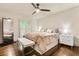 Serene bedroom with hardwood floors, white walls, ceiling fan and plantation shutters at 1385 Northcliff Trce, Roswell, GA 30076