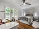 Bright bedroom with hardwood floors, plantation shutters, desk and chair at 1385 Northcliff Trce, Roswell, GA 30076