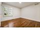 Bedroom featuring hardwood floors and white walls with large windows and plantation shutters at 1385 Northcliff Trce, Roswell, GA 30076