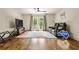 Sitting area in bedroom with hardwood floors, a ceiling fan, and glass doors to the outside at 1385 Northcliff Trce, Roswell, GA 30076