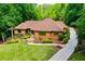 A beautifully landscaped home with a stone walkway and lush green lawn showcasing its elegant exterior at 1385 Northcliff Trce, Roswell, GA 30076