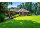 A charming home with a well-kept lawn and beautiful landscaping, creating a welcoming and picturesque setting at 1385 Northcliff Trce, Roswell, GA 30076
